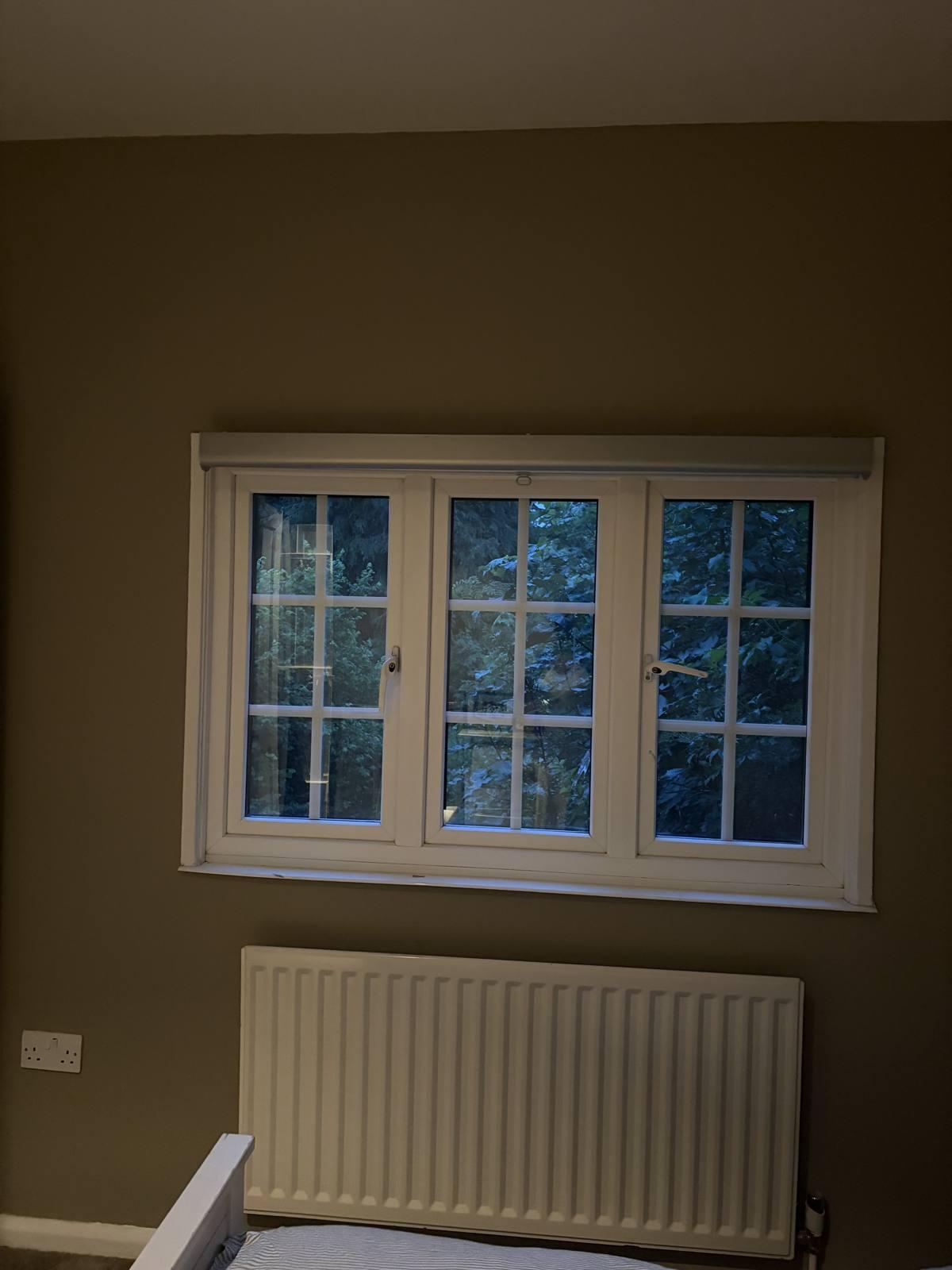 Neptune Honed Slate bedroom walls with white sash window and radiator in evening light, Hertfordshire